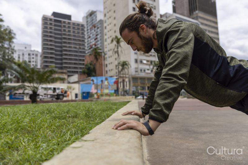 Brazil, Sao Paulo, Man in sports clothing stretching in city