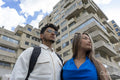 Young couple in front of apartment building