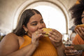 Two young women eating street food