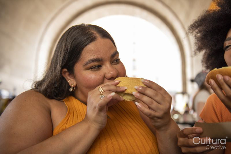 Two young women eating street food