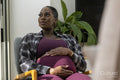 Pregnant woman resting in armchair