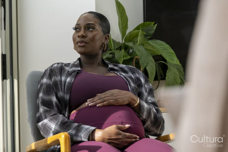 Pregnant woman resting in armchair
