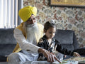 Grandfather playing with grandson at home