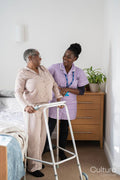 Caregiver assisting smiling senior woman with mobility walker in bedroom