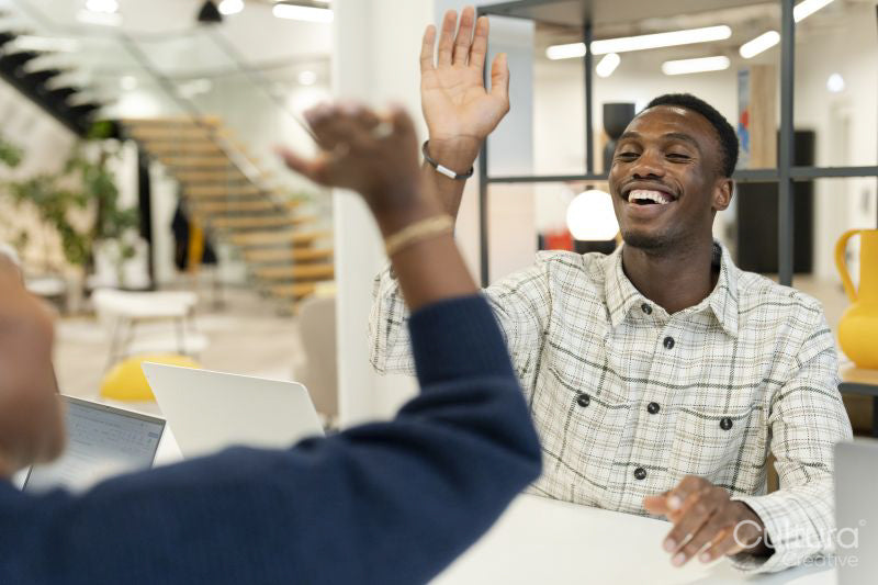 Business people high-fiving in office