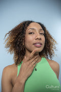 Portrait of woman with curly hair and green top