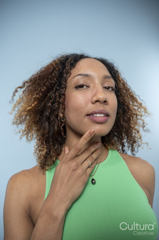 Portrait of woman with curly hair and green top