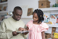 Father with Down syndrome and daughter using tablet