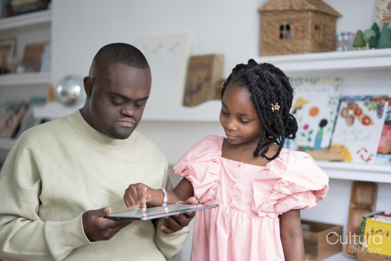 Father with Down syndrome and daughter using tablet