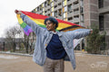 Young woman holding progress pride flag