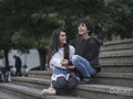 Female couple hugging on stairs in city