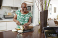 Woman slicing yam in kitchen