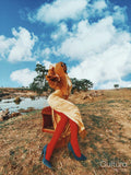 Fashion shot of young woman by river