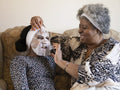 Mother and daughter applying face mask at home
