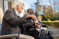 Smiling senior people relaxing on bench in park
