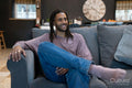 Handsome man with dreads relaxing on sofa