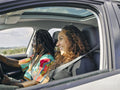 Smiling man and woman in car