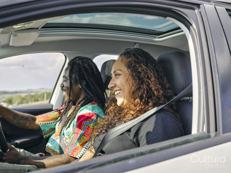 Smiling man and woman in car