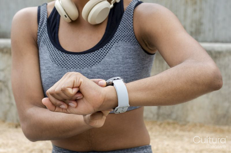 Sporty woman checking time on wristwatch