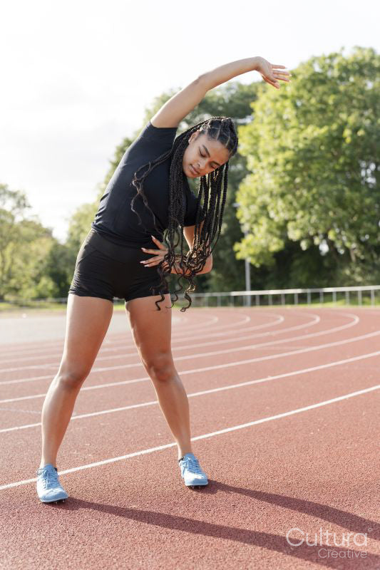 Female athlete stretching arms before training