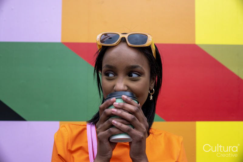 Young woman drinking take-out coffee outdoors