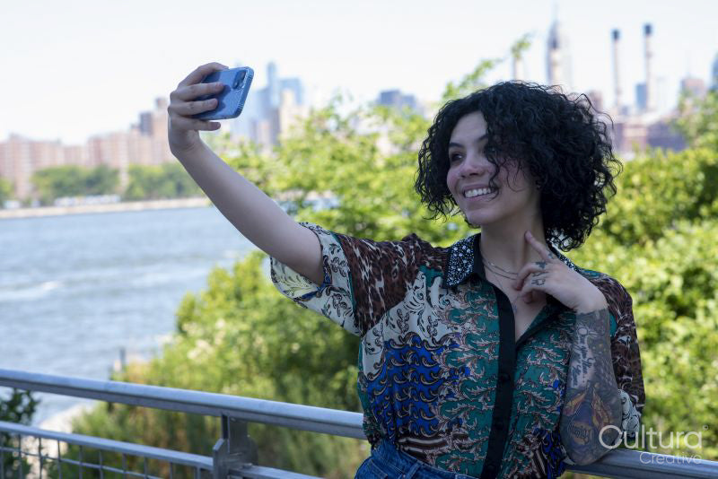 Smiling woman taking selfie in park
