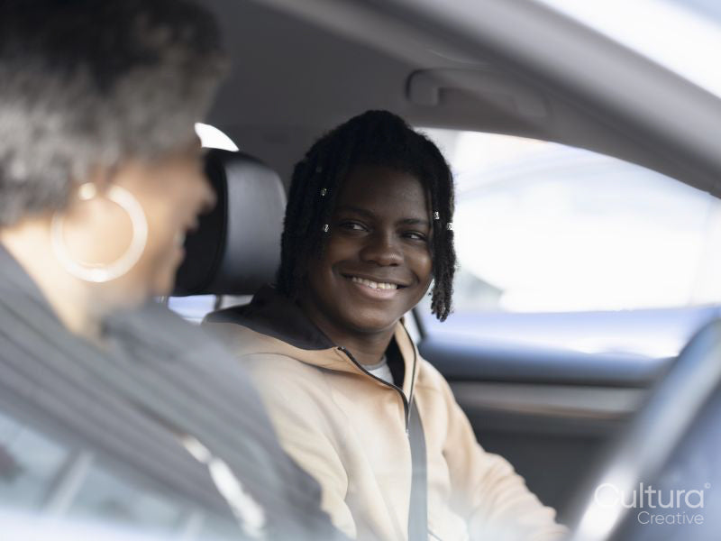 Mother and son sitting in car