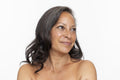 Studio portrait of smiling shirtless woman looking away