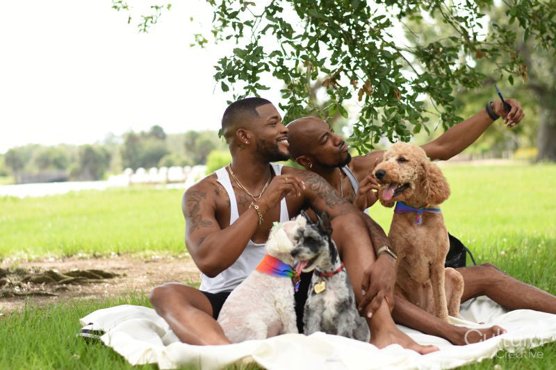 Louisiana, Smiling couple with dogs taking selfie on lawn in park