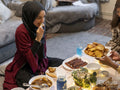 Women sharing food during Ramadan meal at home