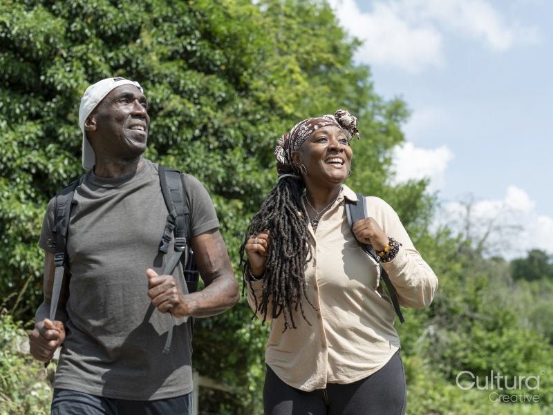 Smiling mature couple hiking in summer