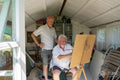 Senior male couple painting at home