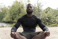 Athletic man meditating in park