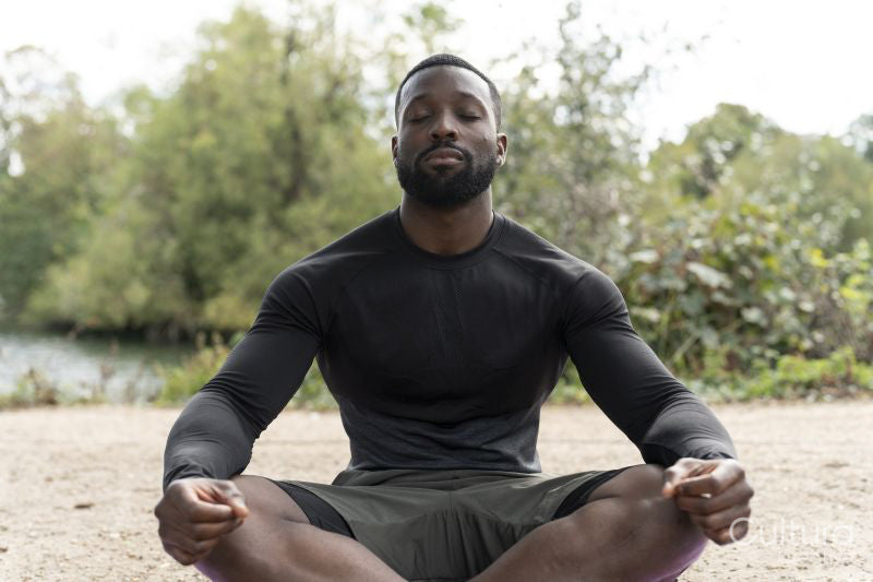 Athletic man meditating in park