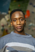 Portrait of woman with climbing wall in background