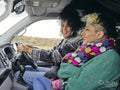 Smiling women traveling by car