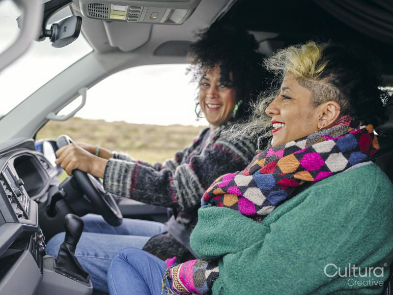 Smiling women traveling by car