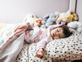 Girl with Down syndrome sleeping in bed
