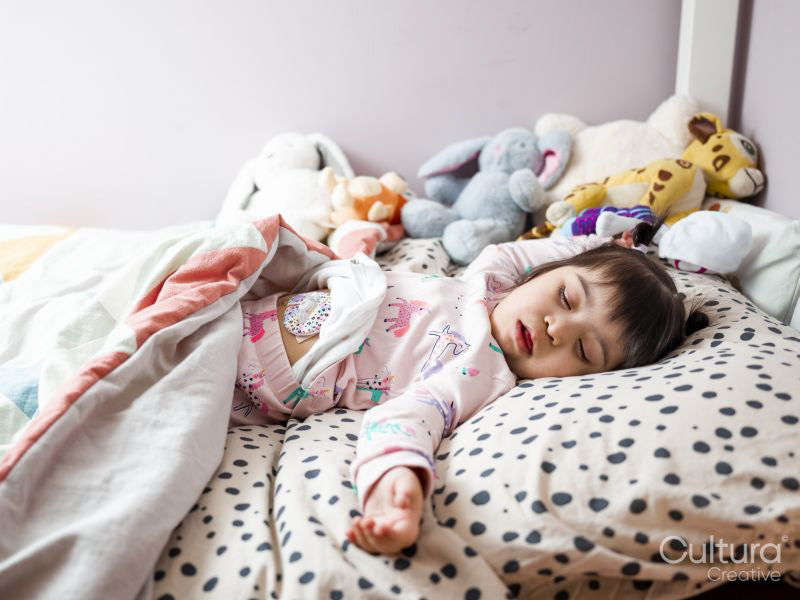 Girl with Down syndrome sleeping in bed