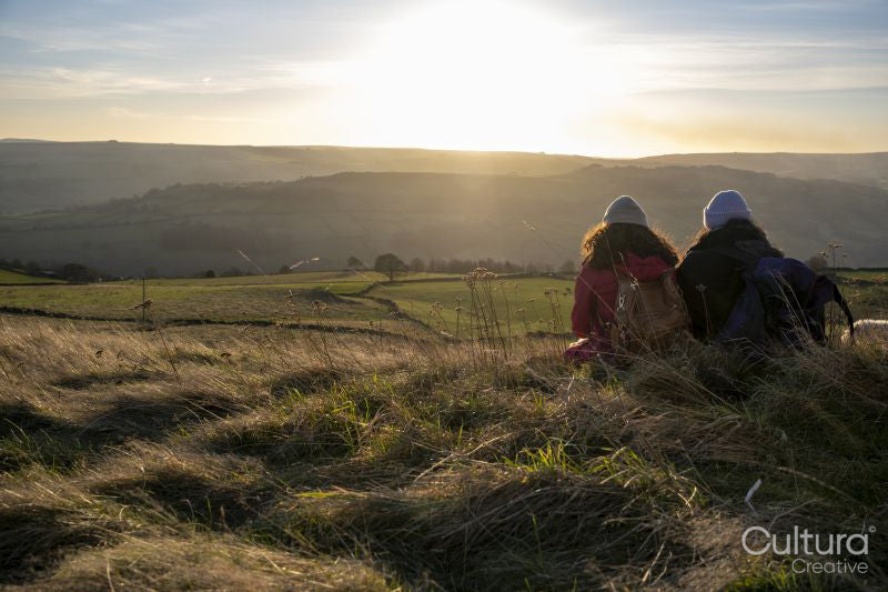Rear view of female hikers looking at sunset