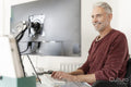 Mature man working on computer at home