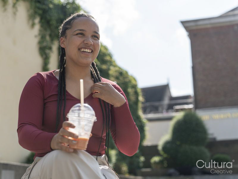 Portrait of smiling woman with smoothie