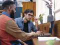 Two businessmen talking in creative studio