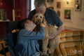 Father and disabled son cuddling dog