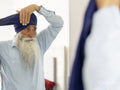 Senior man wrapping turban around head