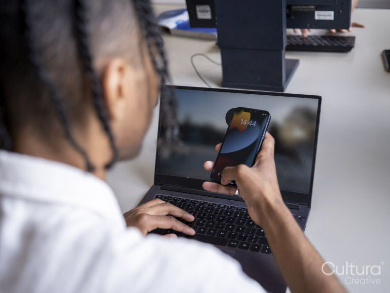 Teenage boy using laptop and smartphone