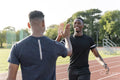 Portrait of two athletes doing high five