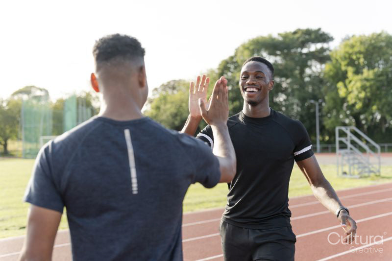 Portrait of two athletes doing high five