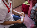 Midsection of nurse holding week pill box
