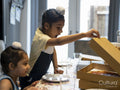 Brothers eating pizza at home